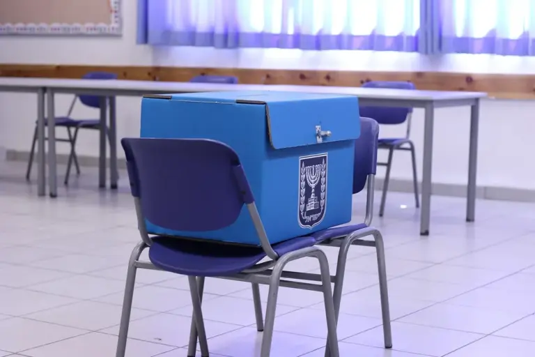 Blue ballot box placed on a chair in a classroom, symbolizing voting and recall processes.