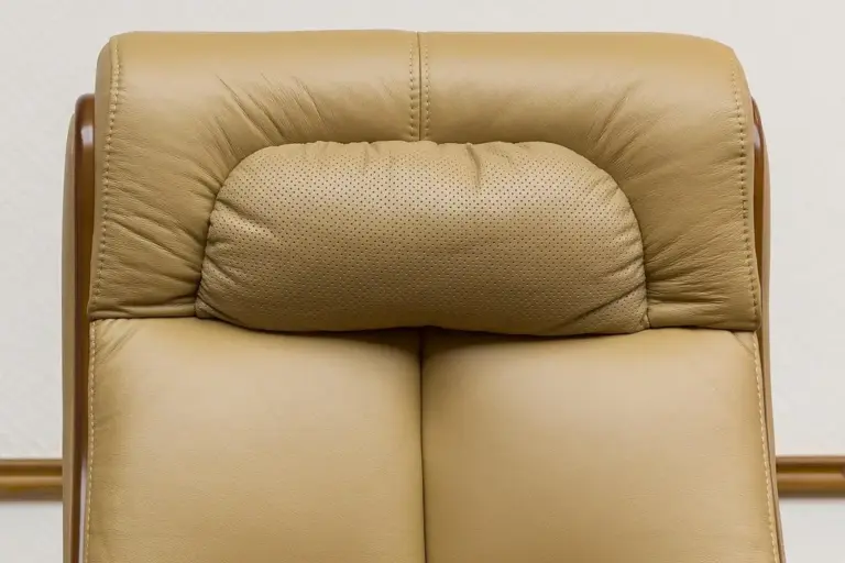 Close-up of a beige leather office chair backrest