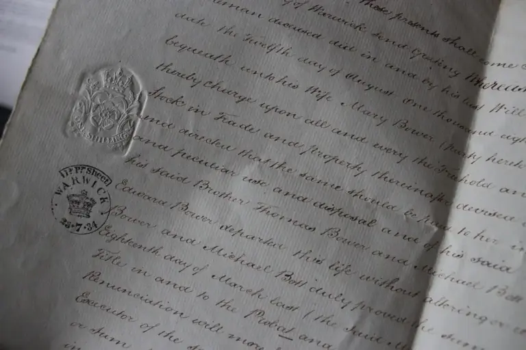 Close-up of a legal document with cursive writing and an official seal imprint