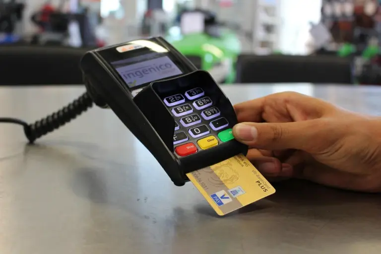 Person using a payment terminal to pay with a credit card.