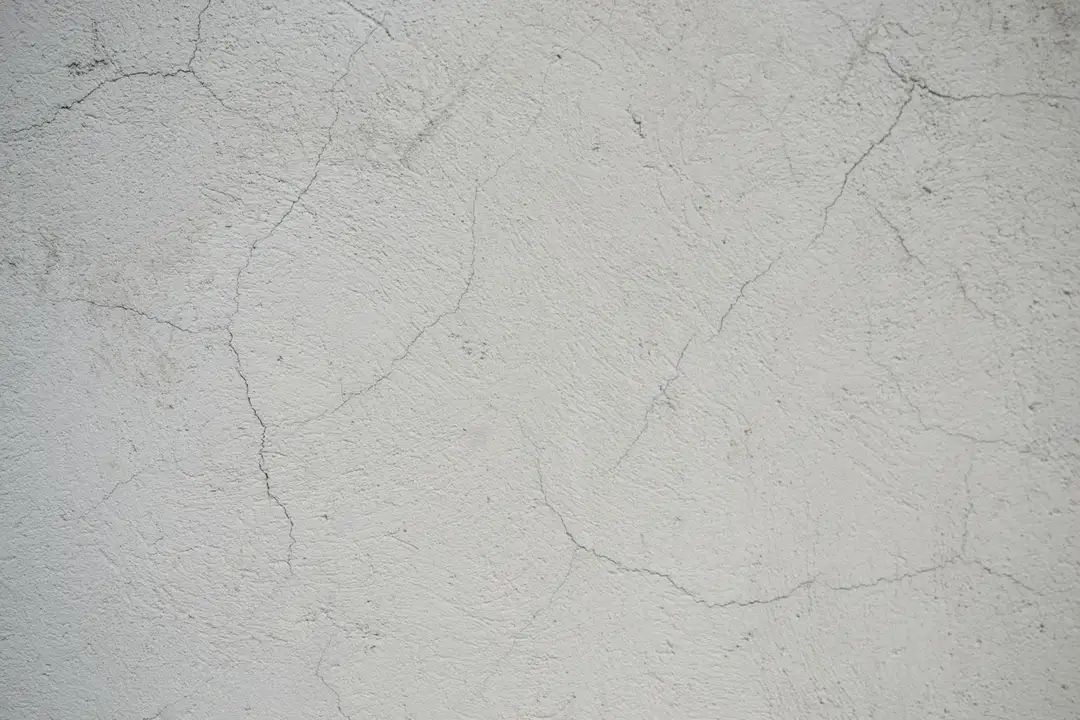 Close-up of a cracked concrete wall symbolizing potential foundation issues in a housing community