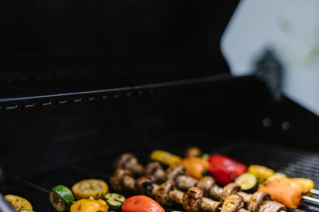 Grilling colorful vegetables on an outdoor barbecue grill.