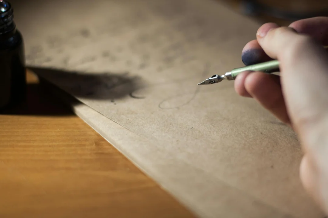 Close-up of a hand holding a fountain pen over parchment, ready to write a formal HOA complaint letter.