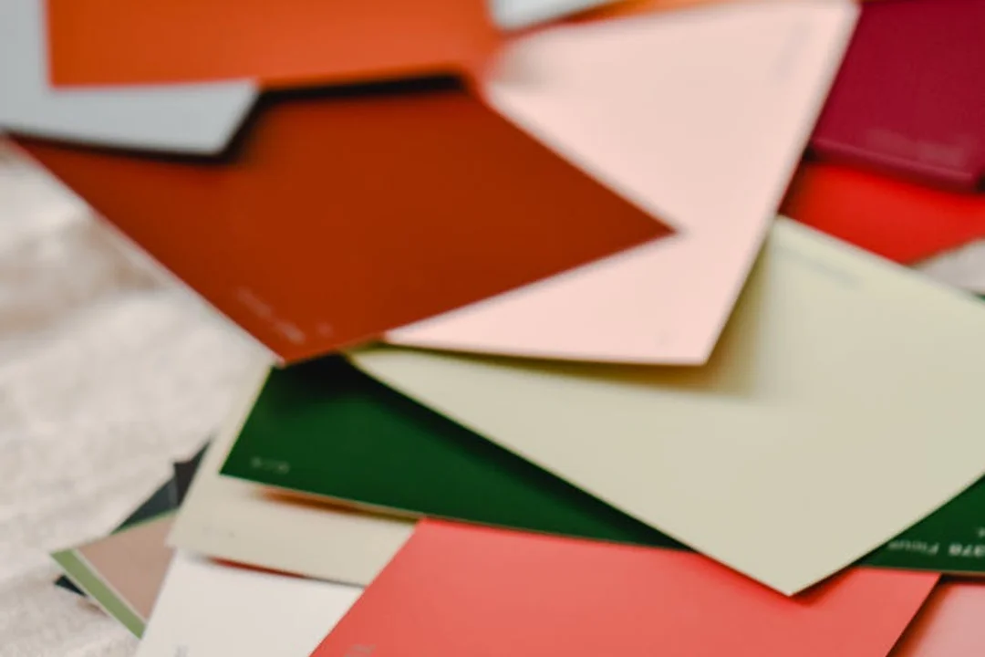 Assorted exterior paint color swatches laid out to compare options for HOA approval