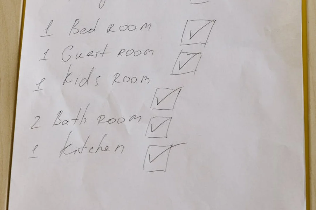 A handwritten checklist listing rooms (bedroom, guest room, kids room, bathrooms, kitchen) with checkboxes, illustrating planning steps for rental restrictions in an HOA