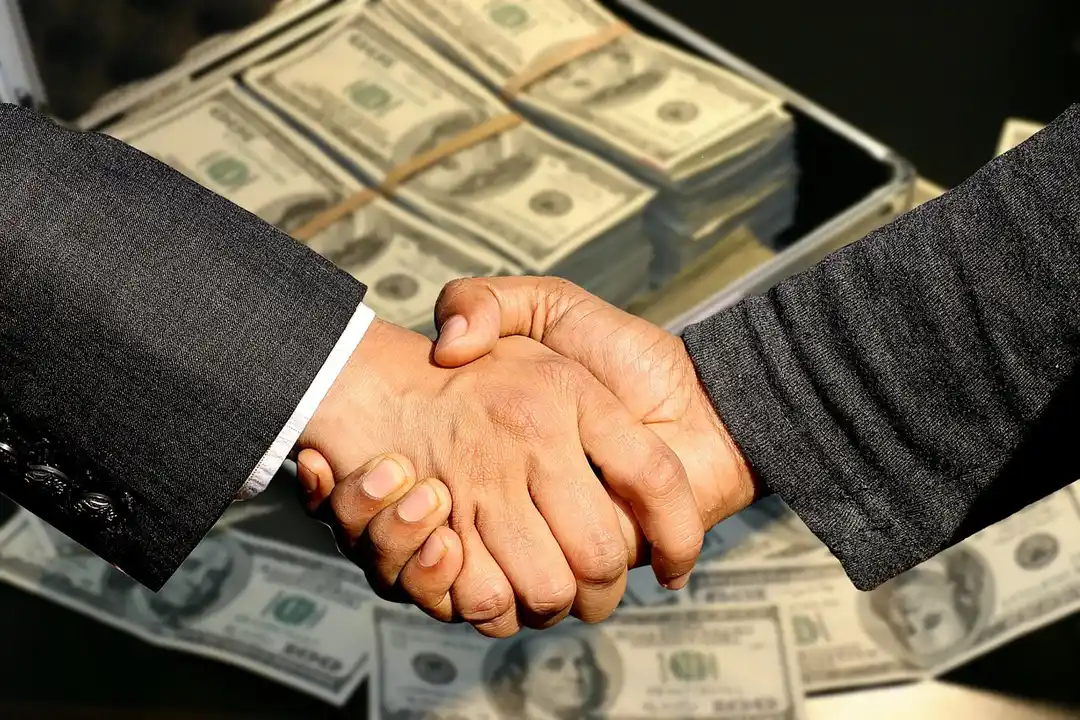 Two businesspeople shake hands with a background of stacked cash, illustrating financial implications and enforcement concerns around HOA agreements.