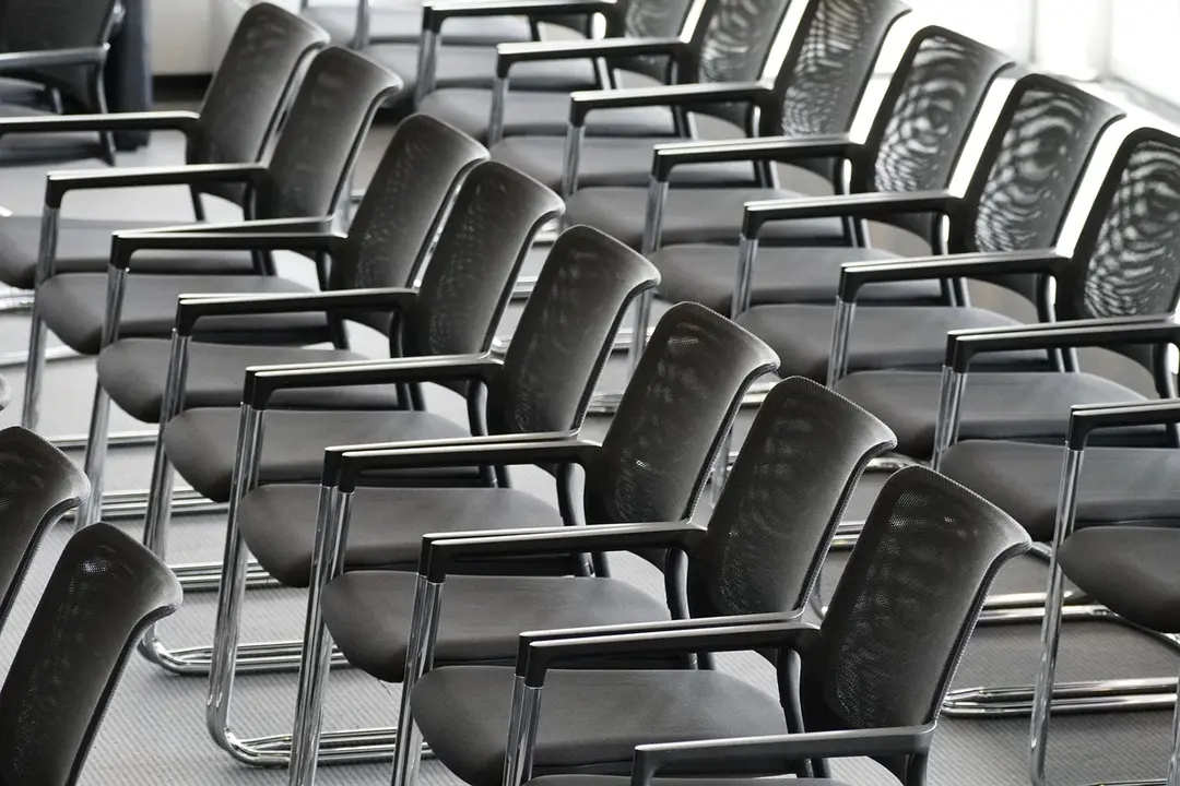 Rows of black conference chairs in a meeting room, arranged for an HOA board discussion.