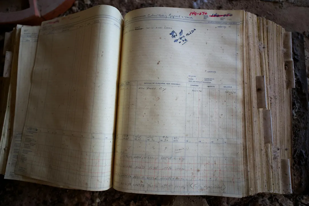 Open, aged ledger with handwritten financial entries and columns, illustrating traditional record-keeping for an homeowners association.