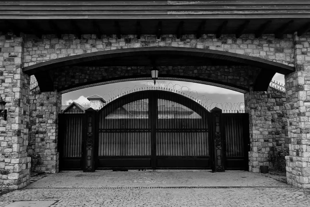 Stone archway and iron gate of a gated residential community.