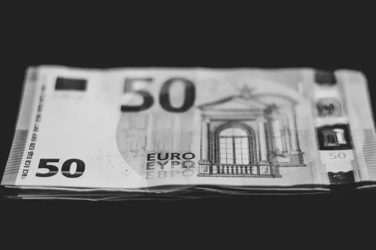 Stack of 50-euro banknotes on a dark surface, illustrating HOA reserve funds.