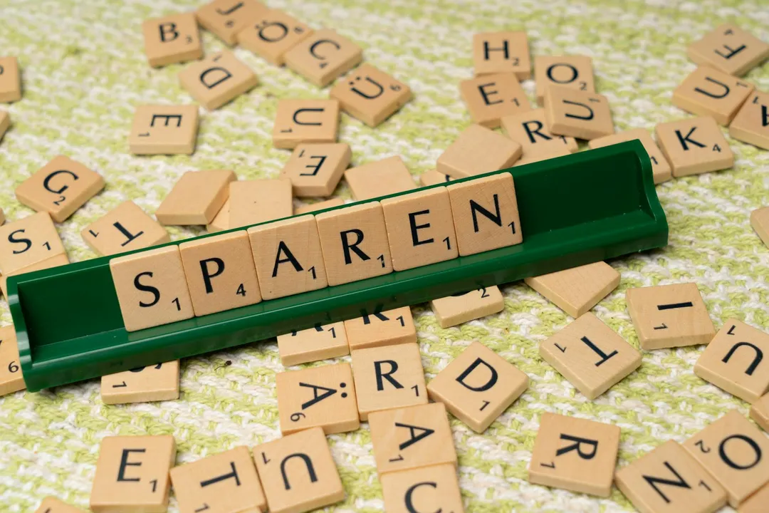 Scrabble tiles scattered on a light surface with a green tile rack displaying letters, conveying the concept of reserve funds.