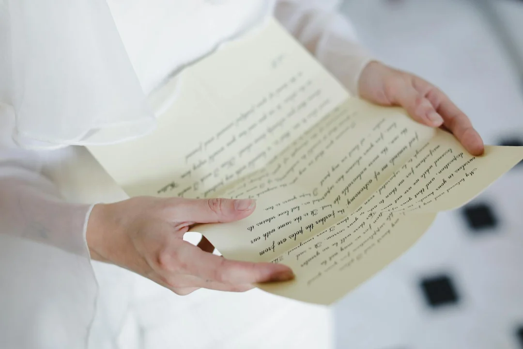 Close-up of hands holding a handwritten letter, symbolizing an HOA warning notice