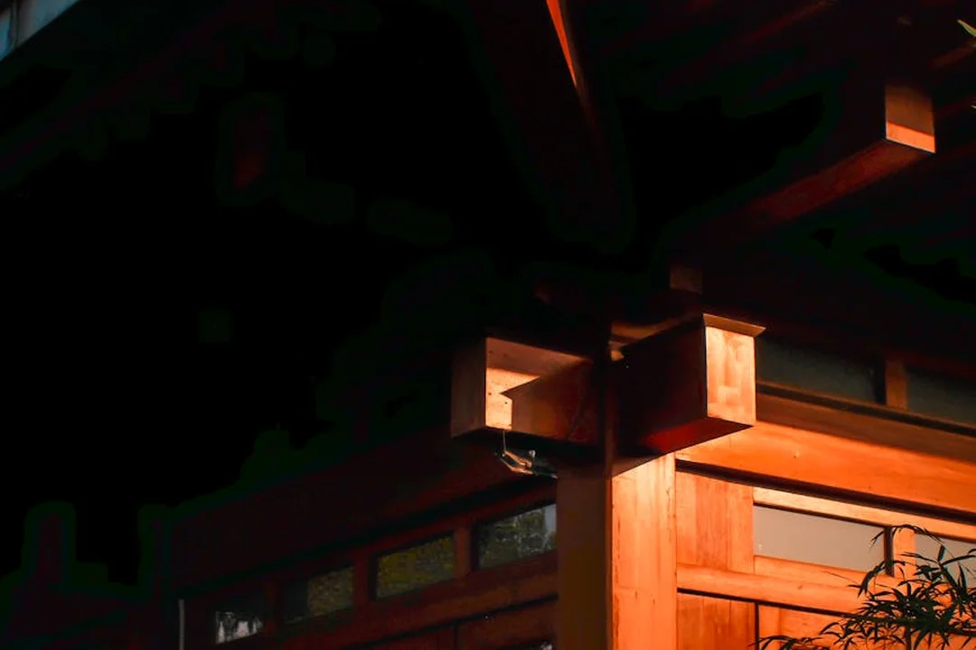 Close-up of a warm wooden doorway with orange lighting, highlighting traditional architecture.