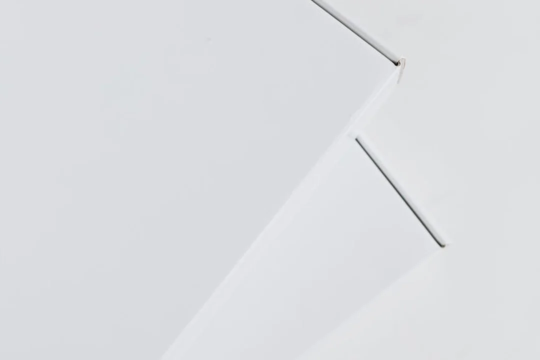 Abstract close-up of white paper edges folded at angles, creating geometric shapes