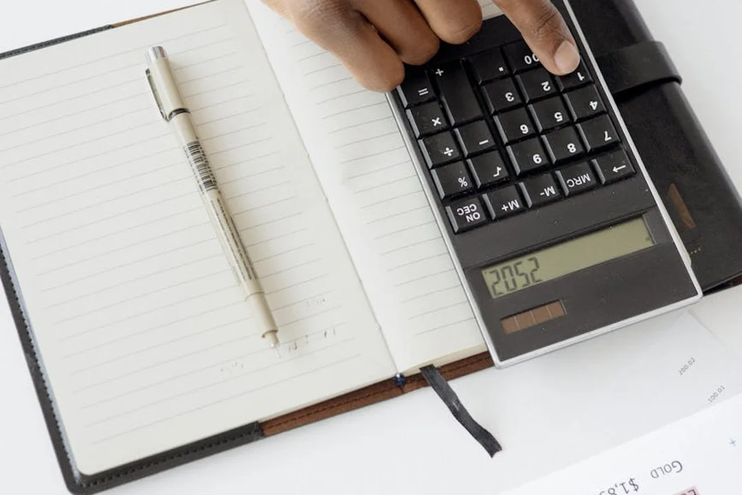 Notebook and calculator on a desk, symbolizing planning and financial review for an association's audit petition.