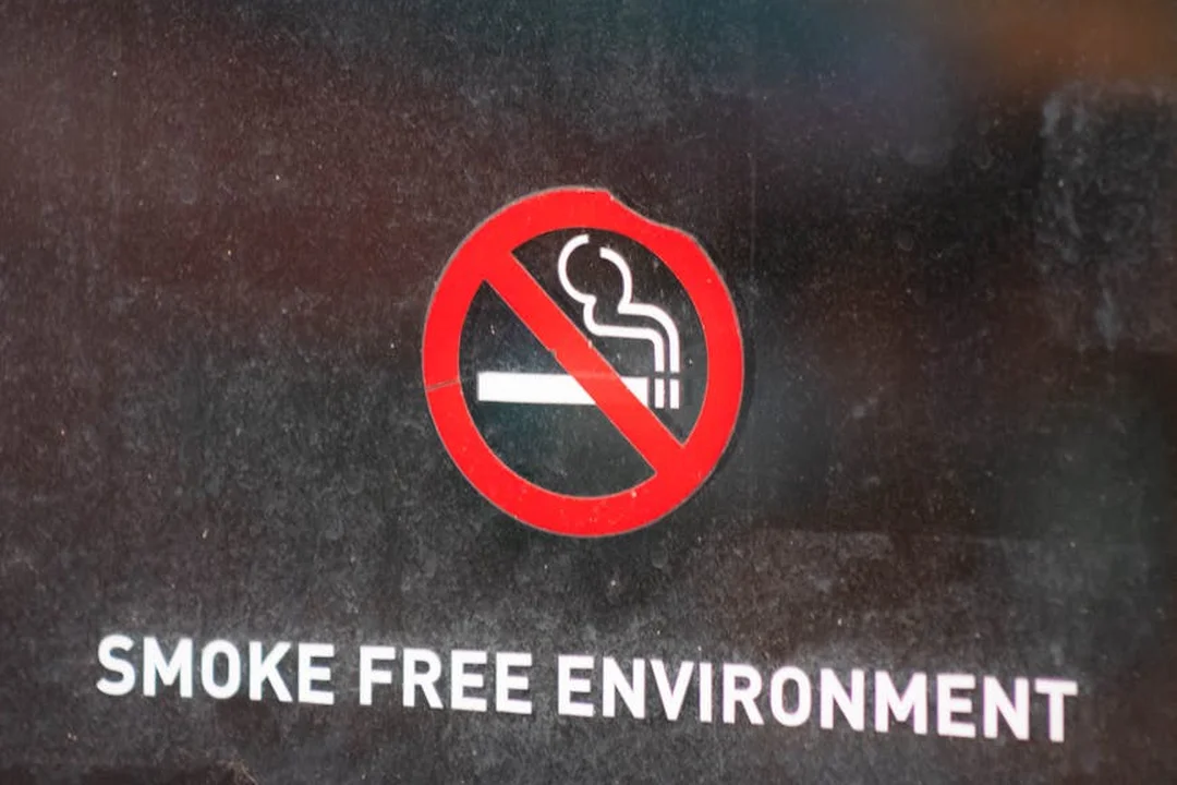 No smoking sign with a cigarette icon inside a red circle with a diagonal line, and the text 'SMOKE FREE ENVIRONMENT' below.