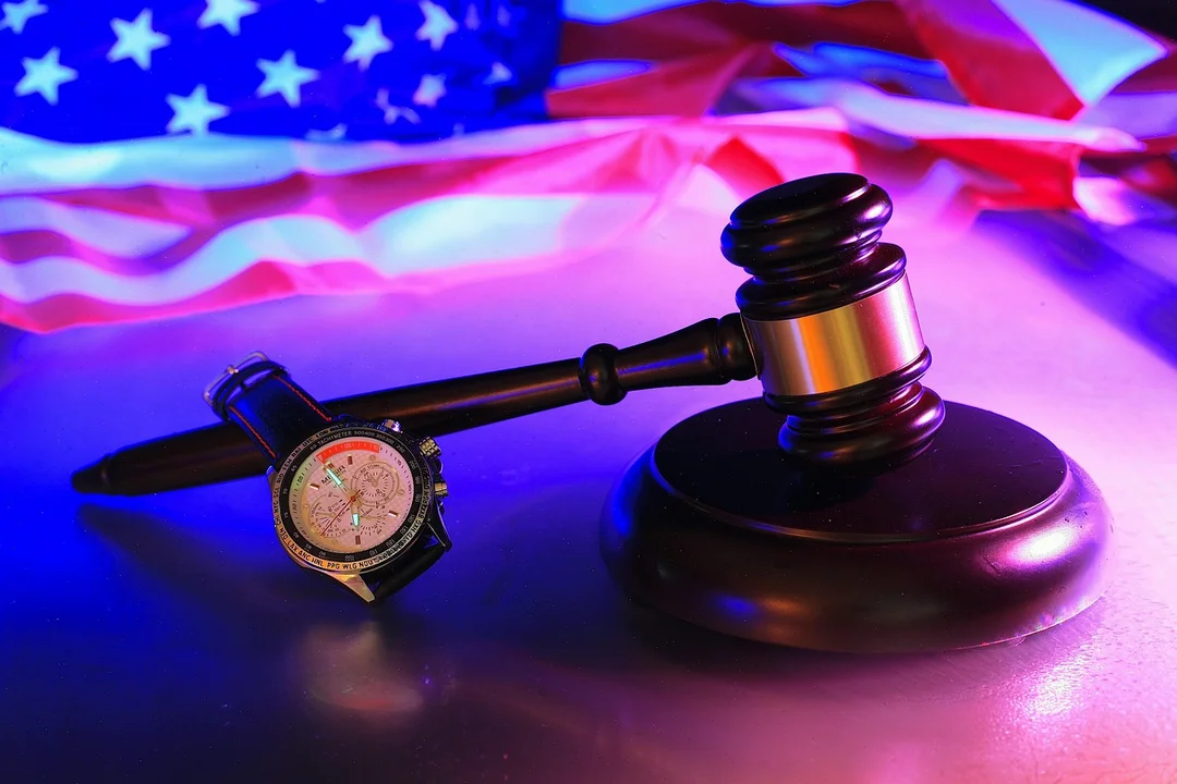 Gavel and compass on a table with an American flag in the background, symbolizing non-binding arbitration for homeowners associations