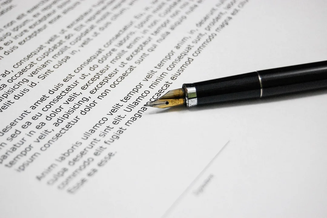 A fountain pen lies on a printed document, symbolizing reviewing contracts during dispute resolution with an HOA or landlord.