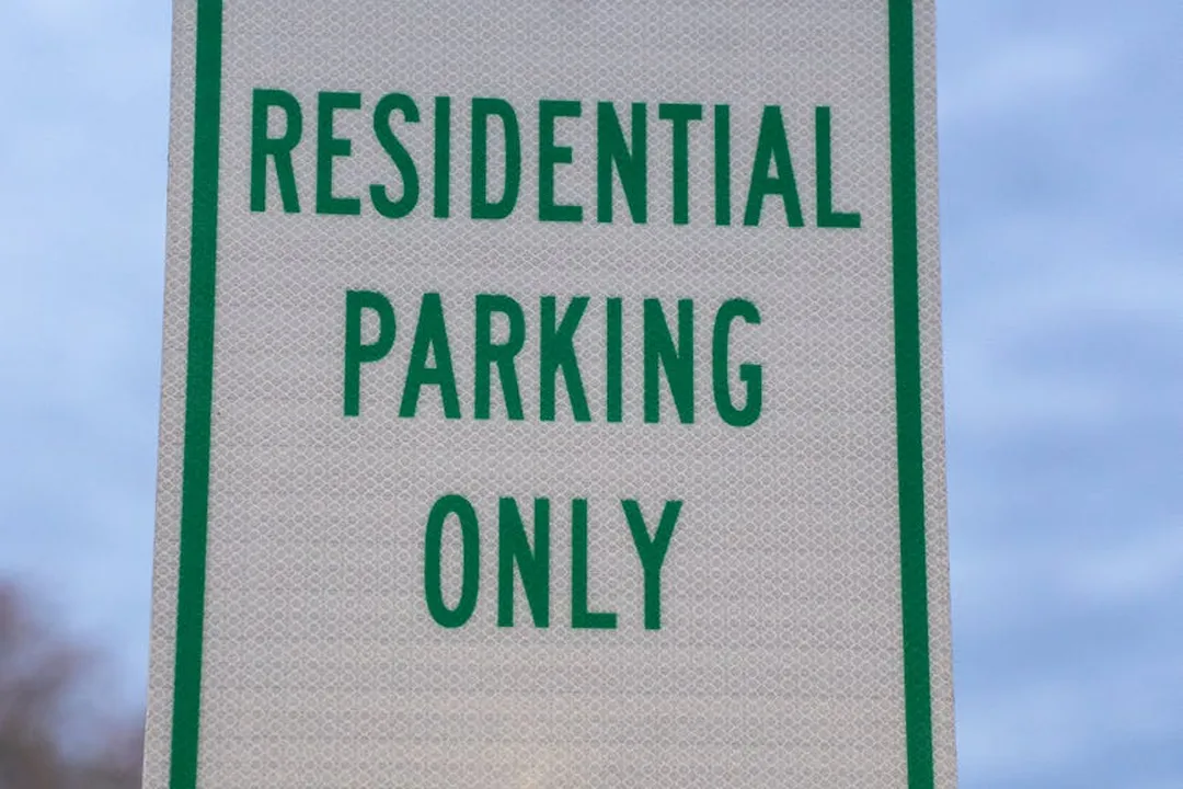 Close-up of a green-and-white sign reading 'Residential Parking Only'.