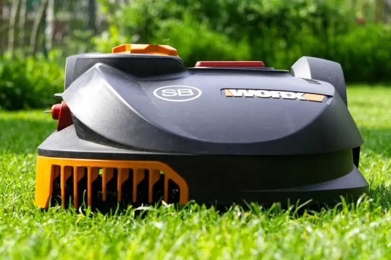 Robotic lawn mower on a green lawn