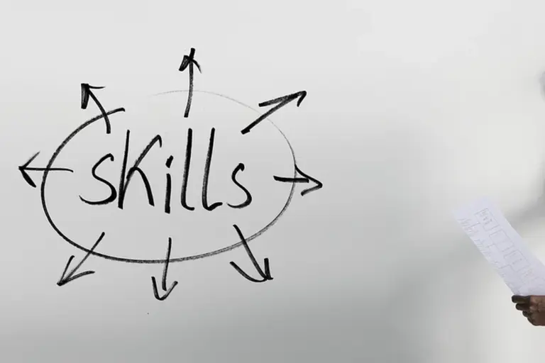 Whiteboard sketch with the word skills in the center and multiple arrows radiating outward.