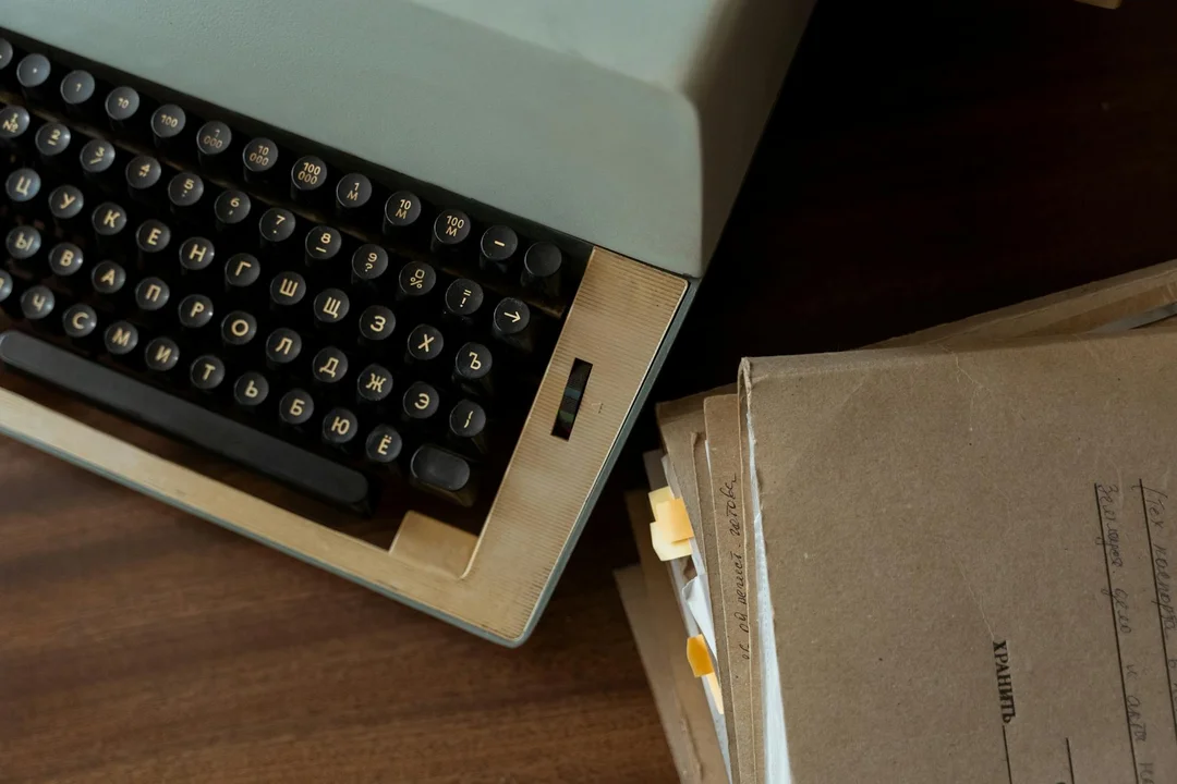Vintage typewriter with manila folders on a wooden desk