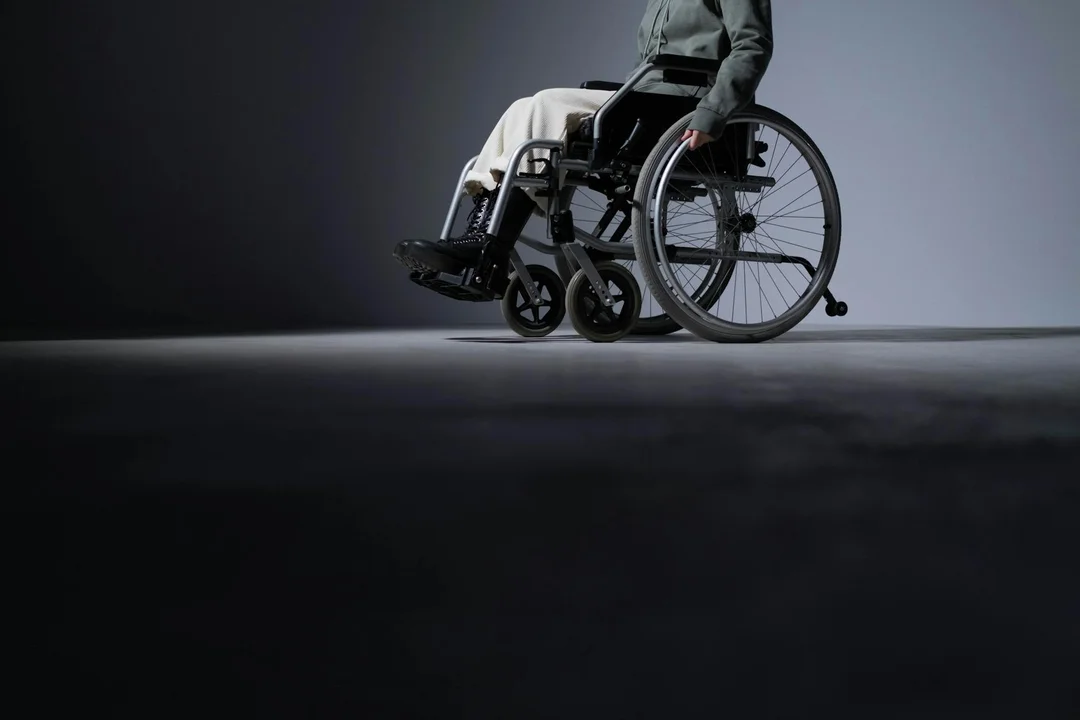 Person in a wheelchair in a dimly lit setting